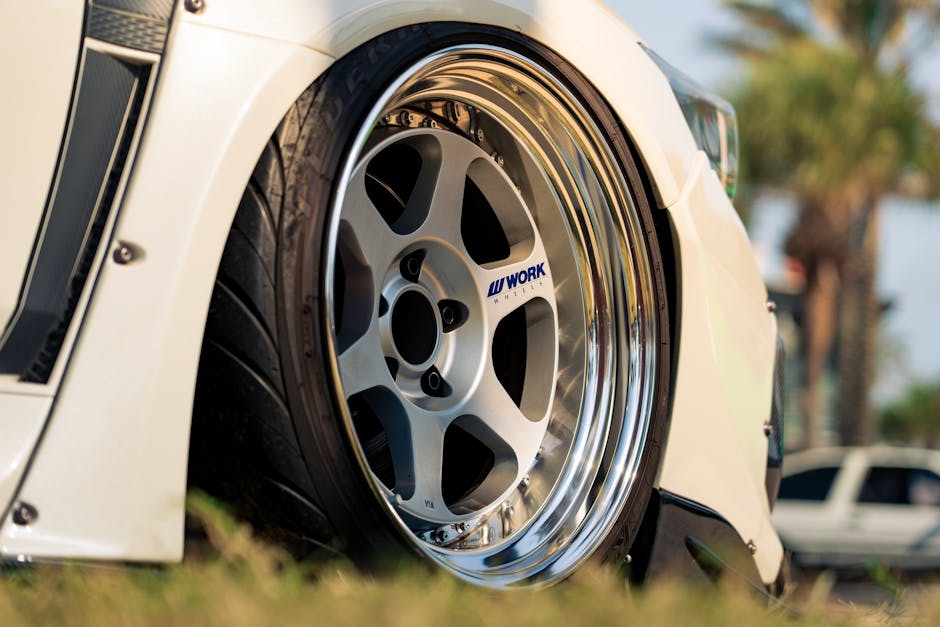 Mechanic installing a new tire on a car wheel