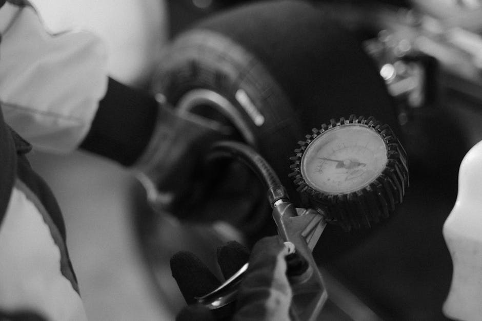 Technician checking tire air pressure and wheel alignment