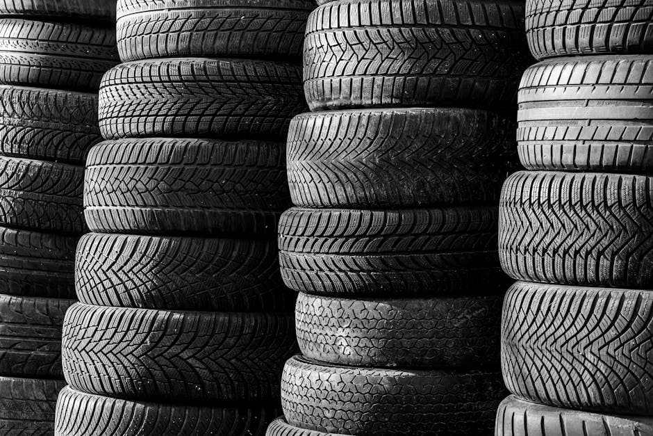 Professional mechanic replacing a car tire in a well-lit auto shop